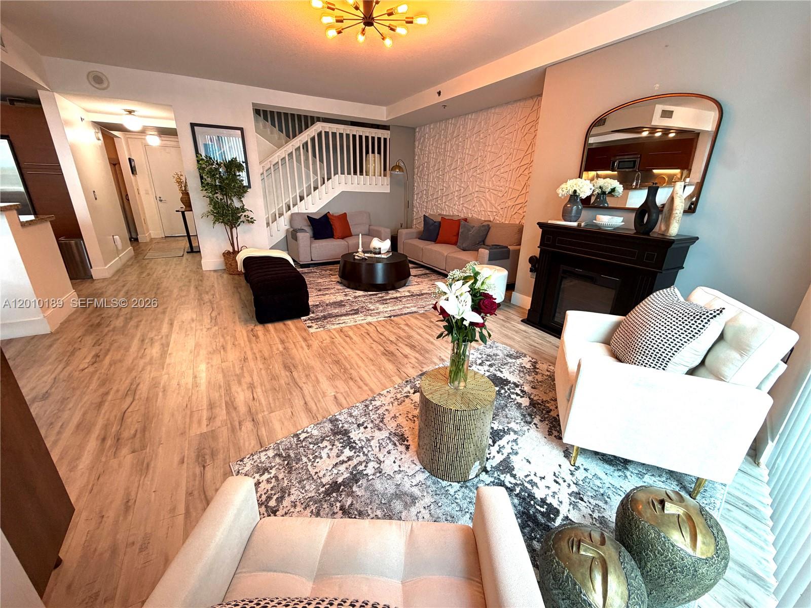 2641 North Flamingo Road, Unit TH4N Sunrise, FL 33323 - Photo 14 of 30 a living room with furniture and a mirror