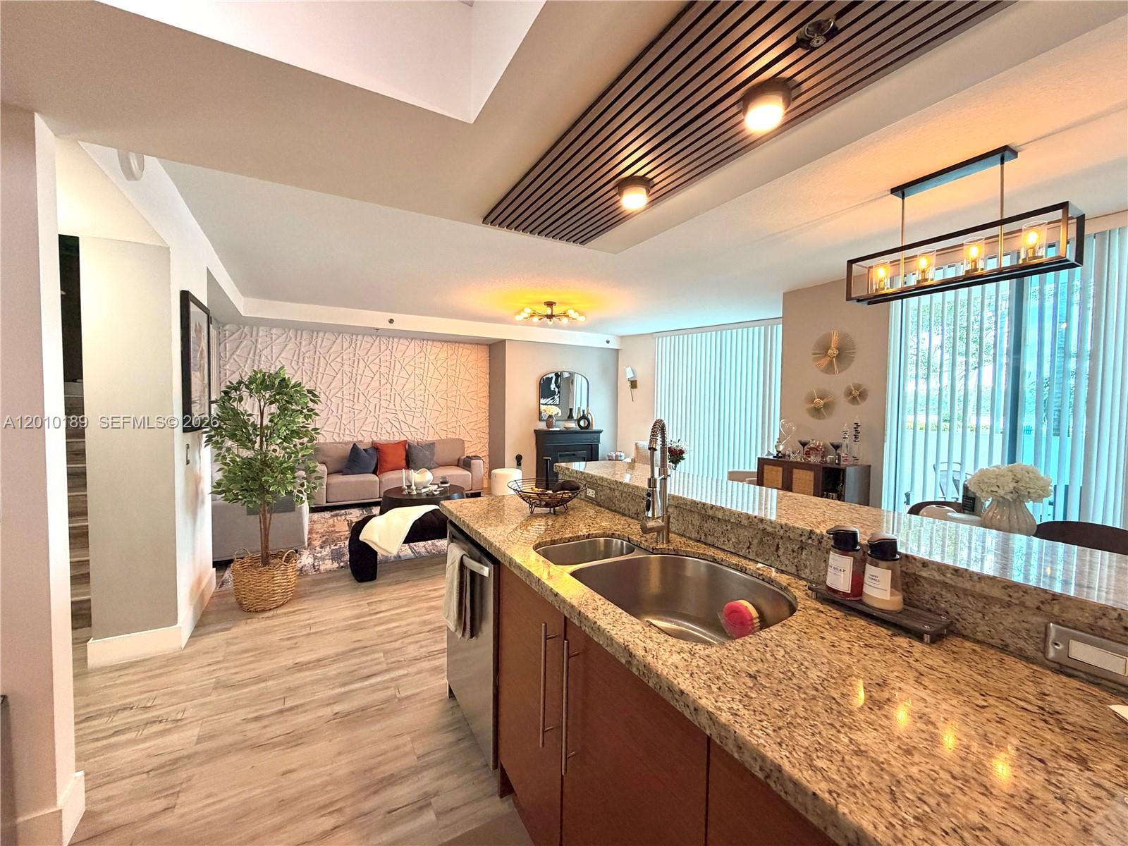 2641 North Flamingo Road, Unit TH4N Sunrise, FL 33323 - Photo 16 of 30 a kitchen that has a sink and a large window