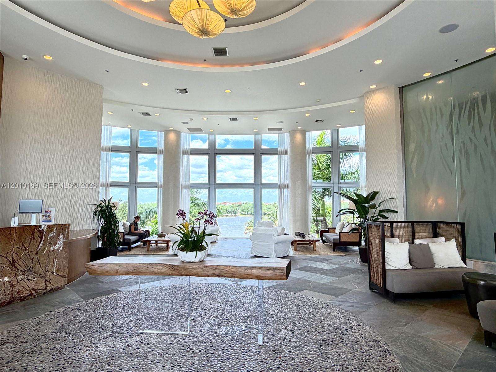 2641 North Flamingo Road, Unit TH4N Sunrise, FL 33323 - Photo 2 of 30 a living room with furniture and large windows
