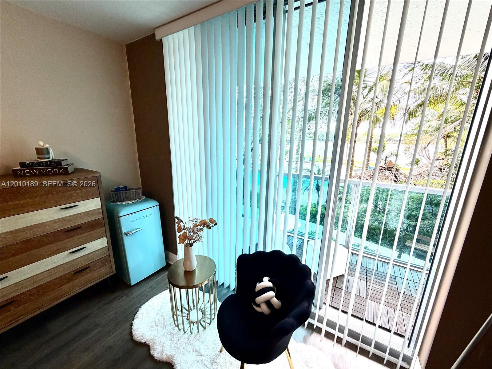 2641 North Flamingo Road, Unit TH4N Sunrise, FL 33323 - Photo 24 of 30 a living room with furniture and a floor to ceiling window
