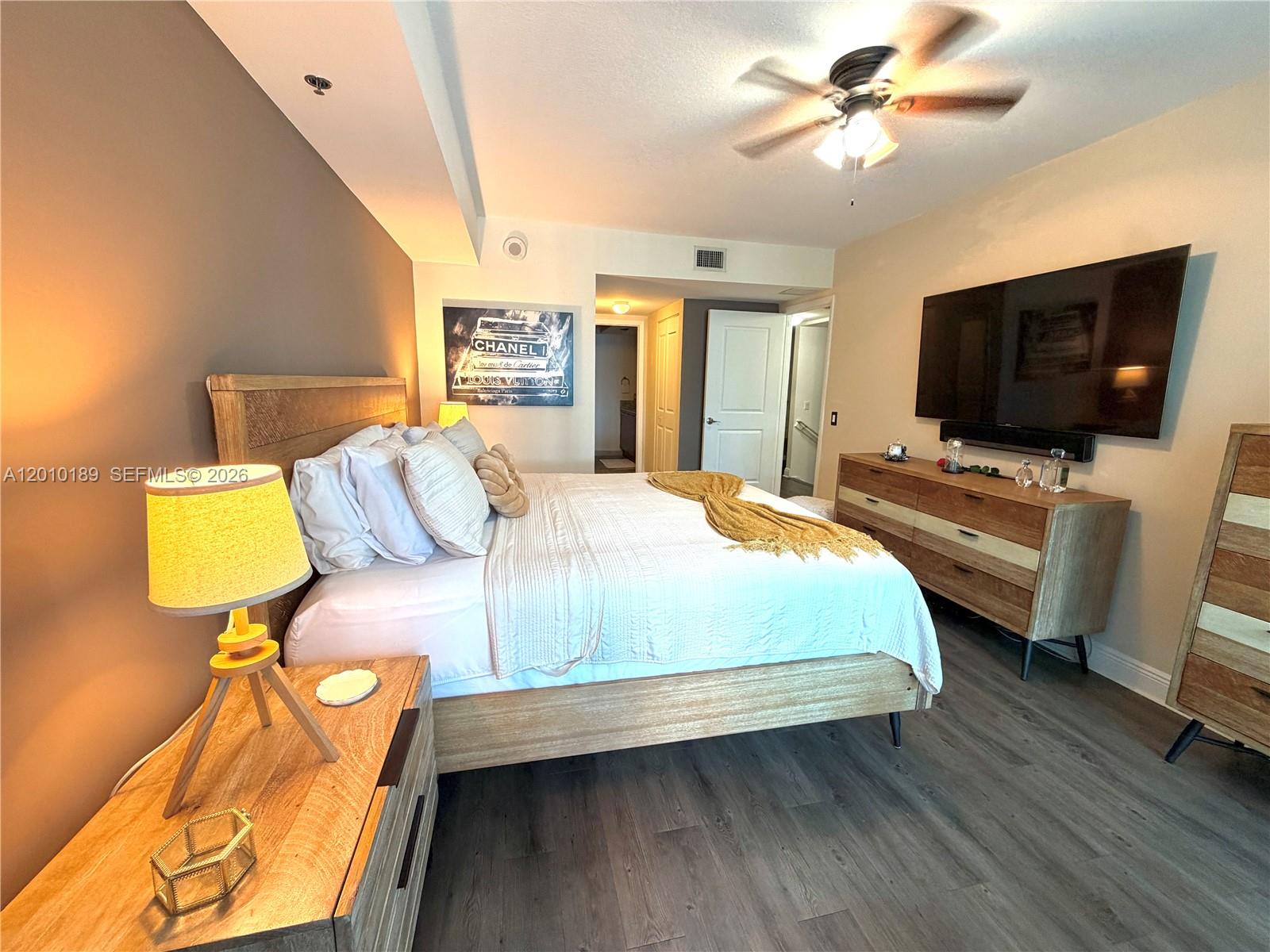 2641 North Flamingo Road, Unit TH4N Sunrise, FL 33323 - Photo 25 of 30 a bedroom with a bed and flat screen tv