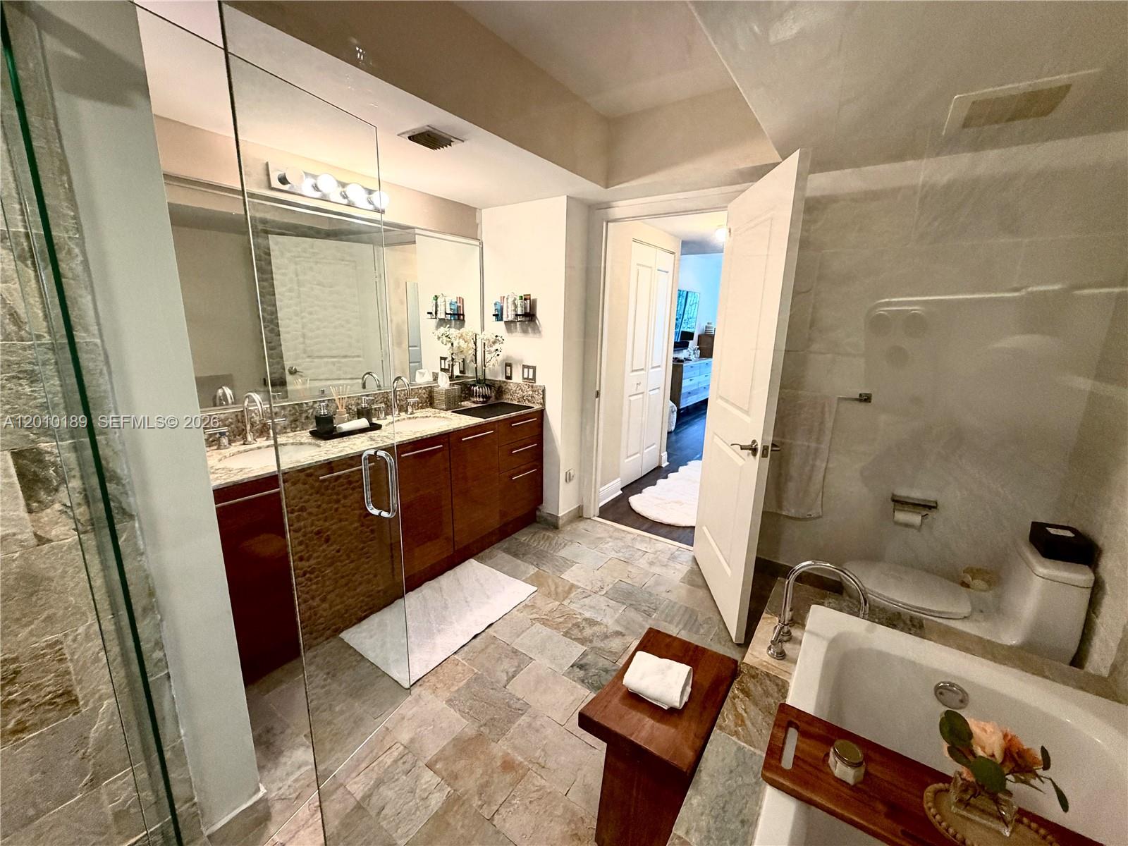 2641 North Flamingo Road, Unit TH4N Sunrise, FL 33323 - Photo 26 of 30 a large bathroom with a tub sink and mirror