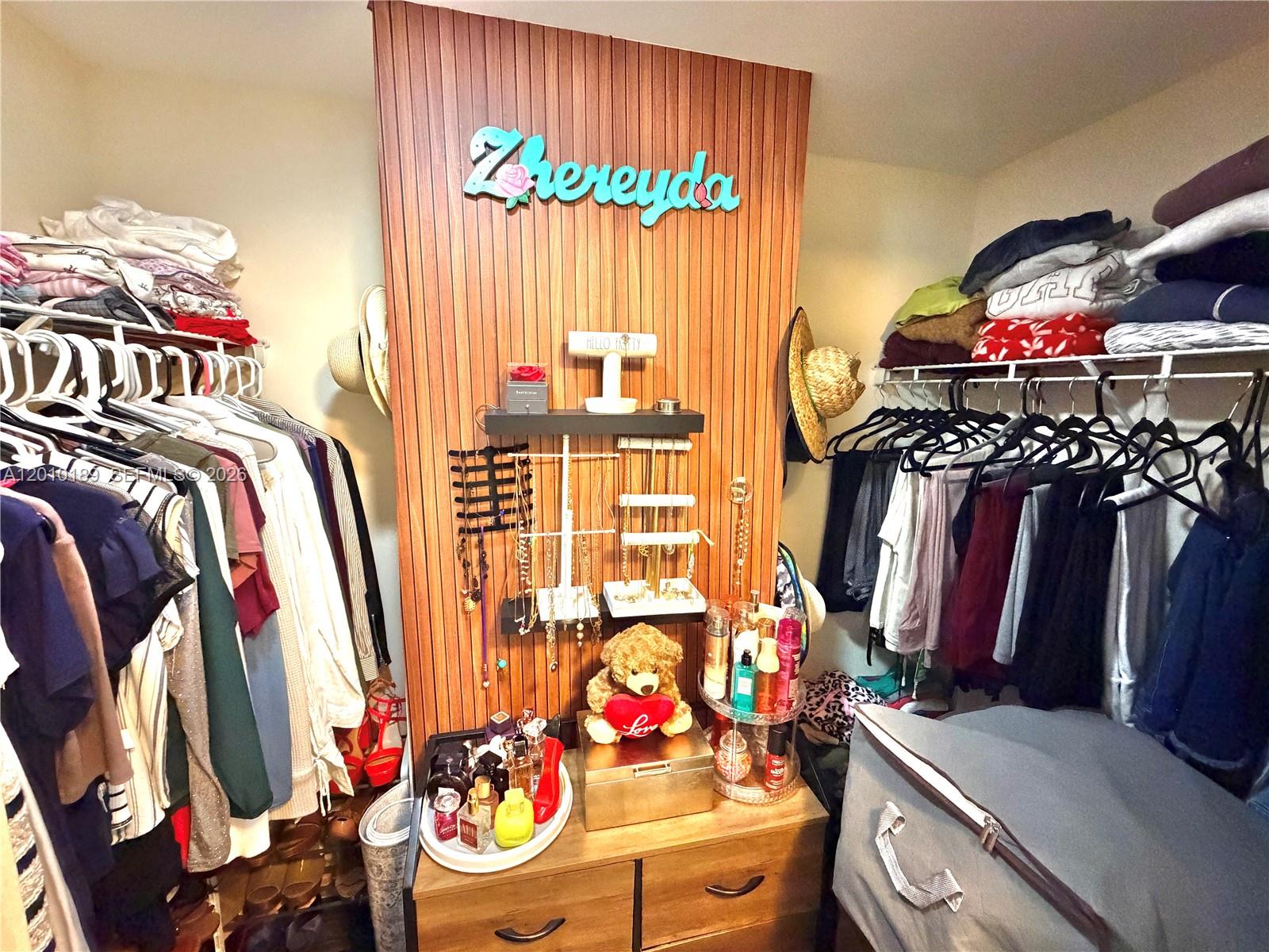 2641 North Flamingo Road, Unit TH4N Sunrise, FL 33323 - Photo 28 of 30 a view of walk in closet with clothes and shoes