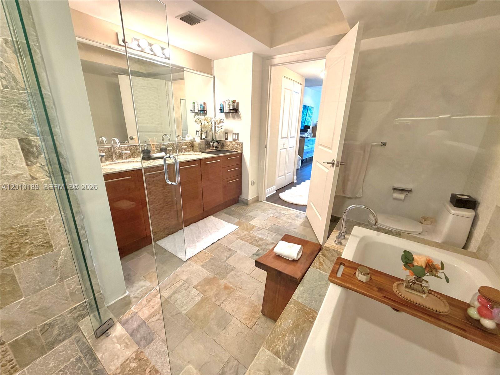 2641 North Flamingo Road, Unit TH4N Sunrise, FL 33323 - Photo 29 of 30 a bathroom with a tub sink and mirror
