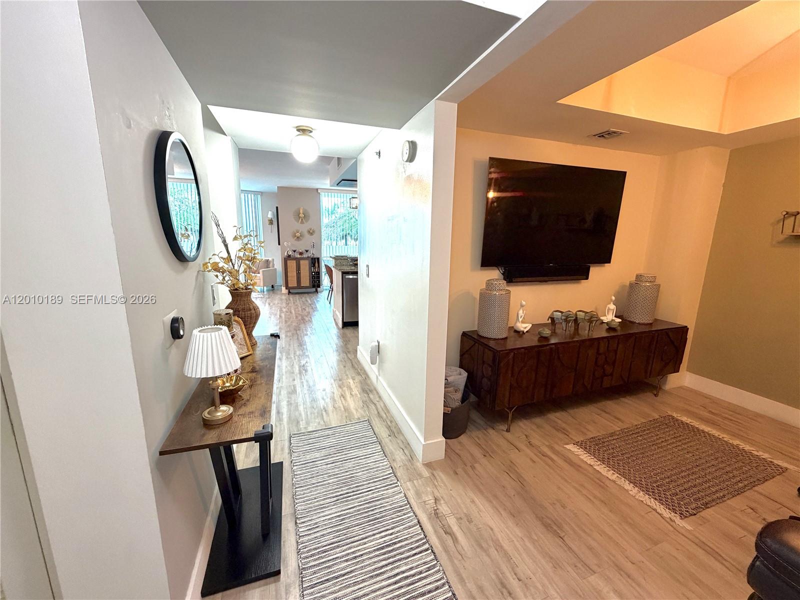 2641 North Flamingo Road, Unit TH4N Sunrise, FL 33323 - Photo 9 of 30 a living room with furniture and a flat screen tv