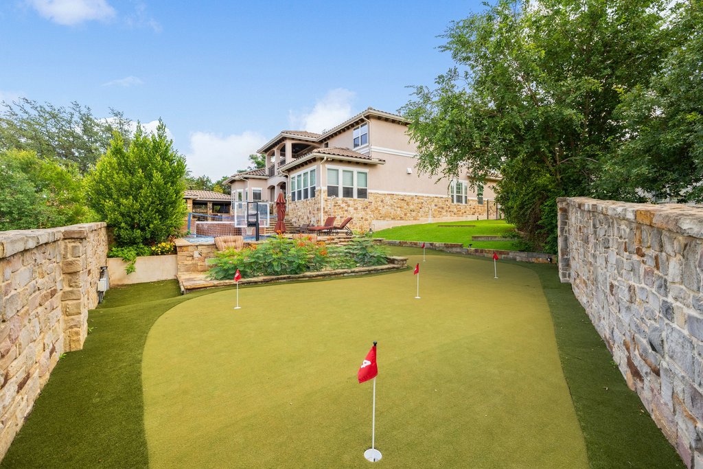 109 Largo Cove Austin, TX 78734 - Photo 38 of 40 An exquisite putting green awaits, perfectly complementing the elegant stone-clad residence.
