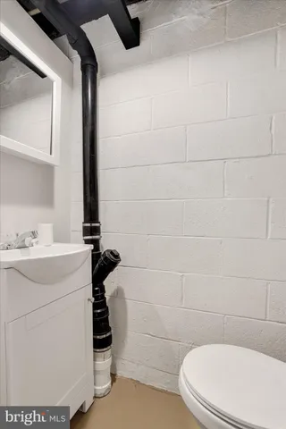 a bathroom with a sink a toilet and a mirror