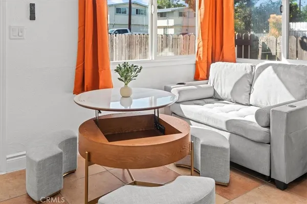 a living room with furniture and a potted plant