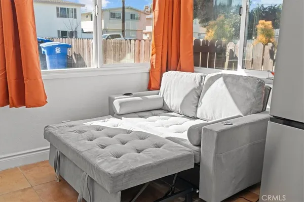 a bed sitting in a bedroom next to a window