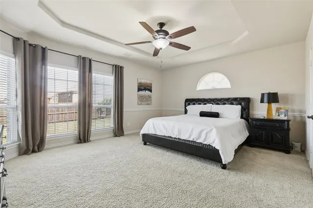 a bedroom with a bed and glass walk in closet