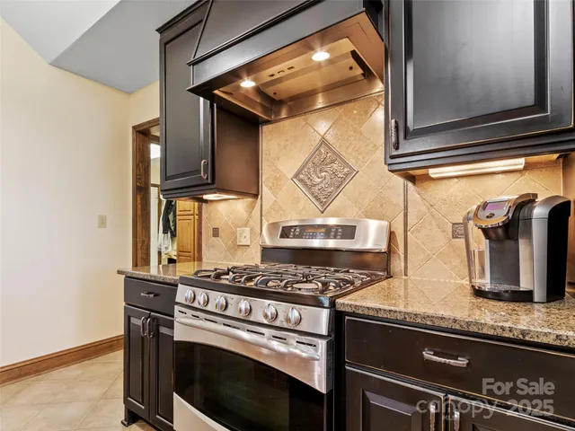 a kitchen with granite countertop a stove and a microwave