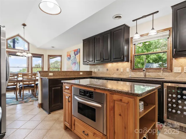 a kitchen that has a stove and a table in it
