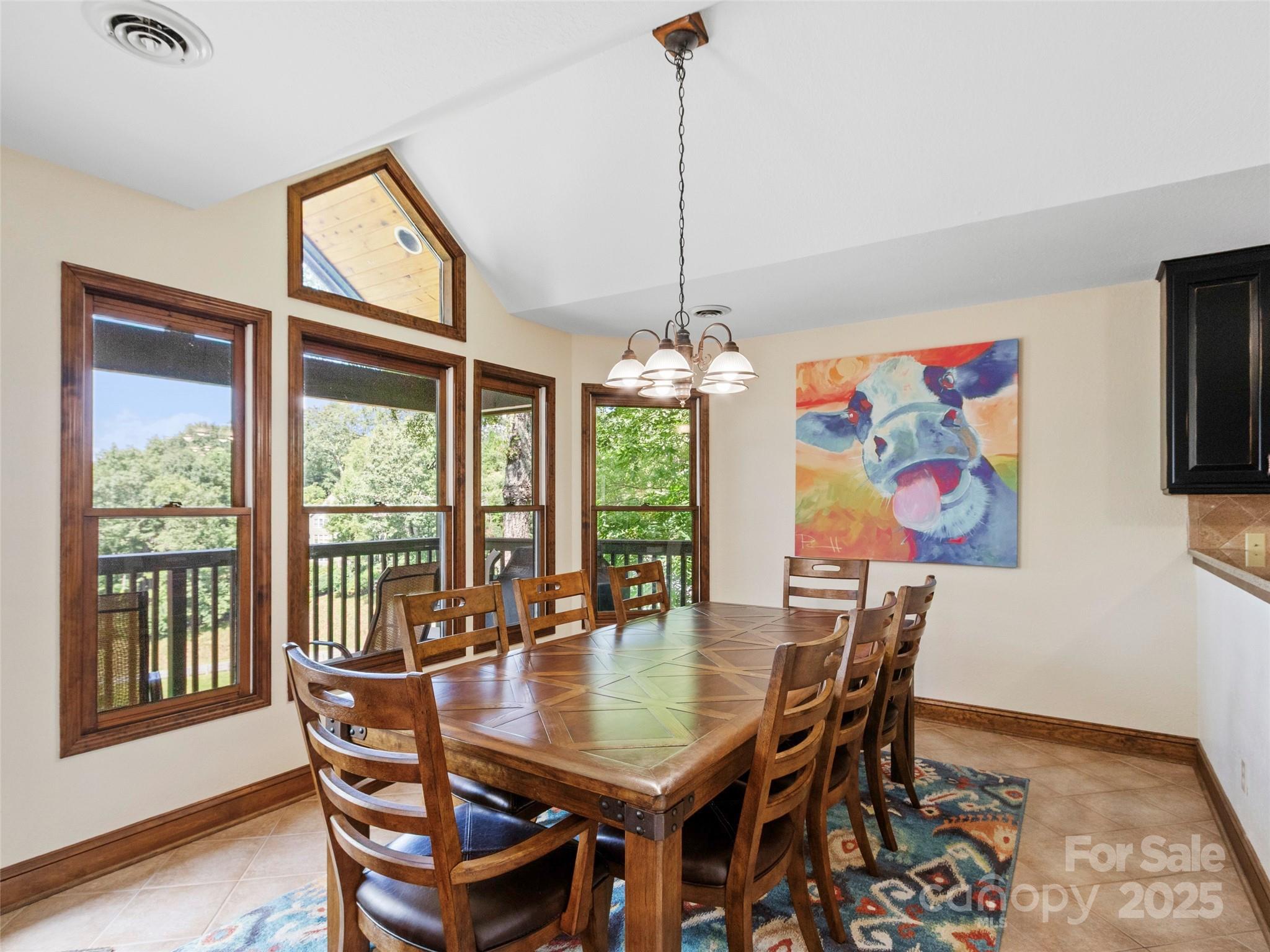 91 Brandy Run Road Burnsville, NC 28714 - Photo 15 of 48 a dining room with furniture a window and a chandelier