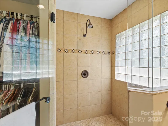 a en suite bathroom with a granite countertop sink and a mirror