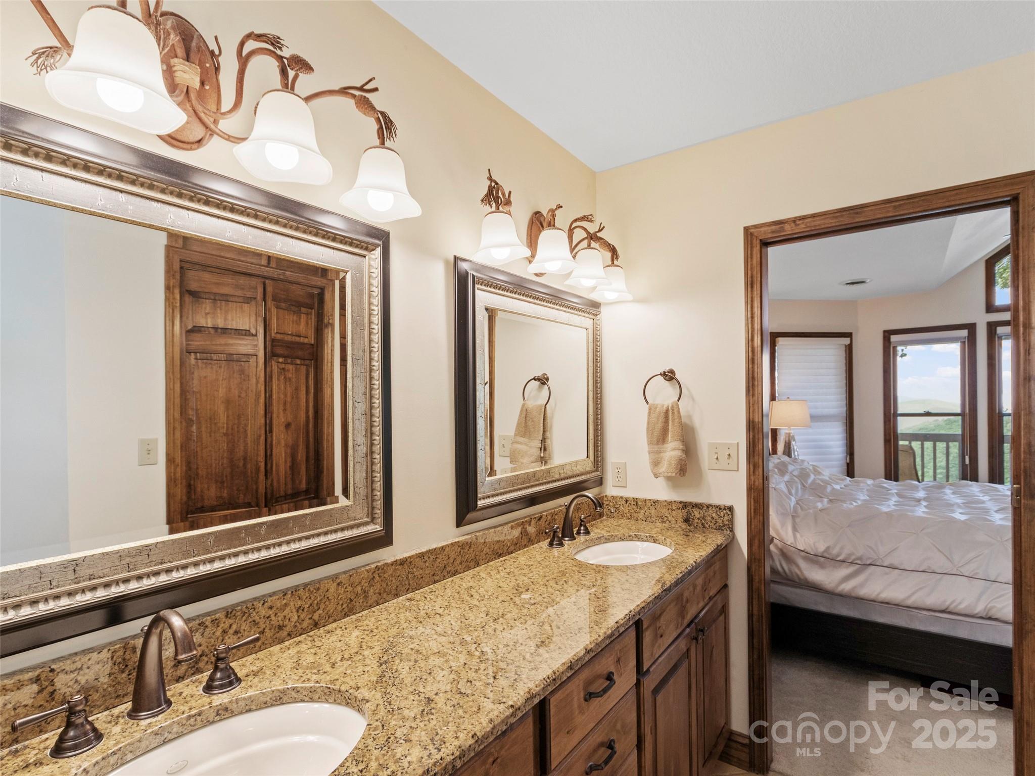 91 Brandy Run Road Burnsville, NC 28714 - Photo 22 of 48 a en suite bathroom with a granite countertop sink and a mirror