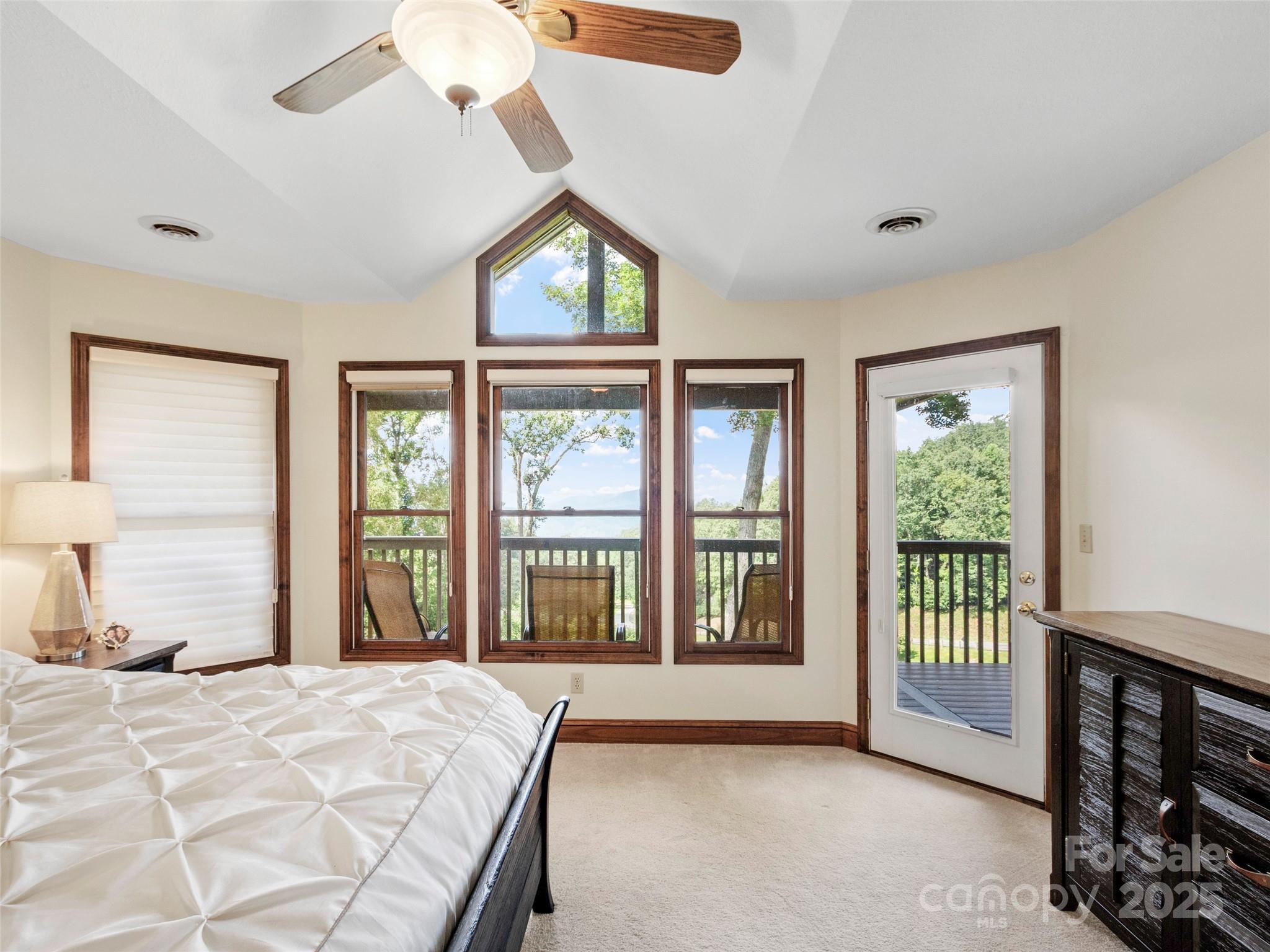 91 Brandy Run Road Burnsville, NC 28714 - Photo 23 of 48 a spacious bedroom with a large bed and a large window