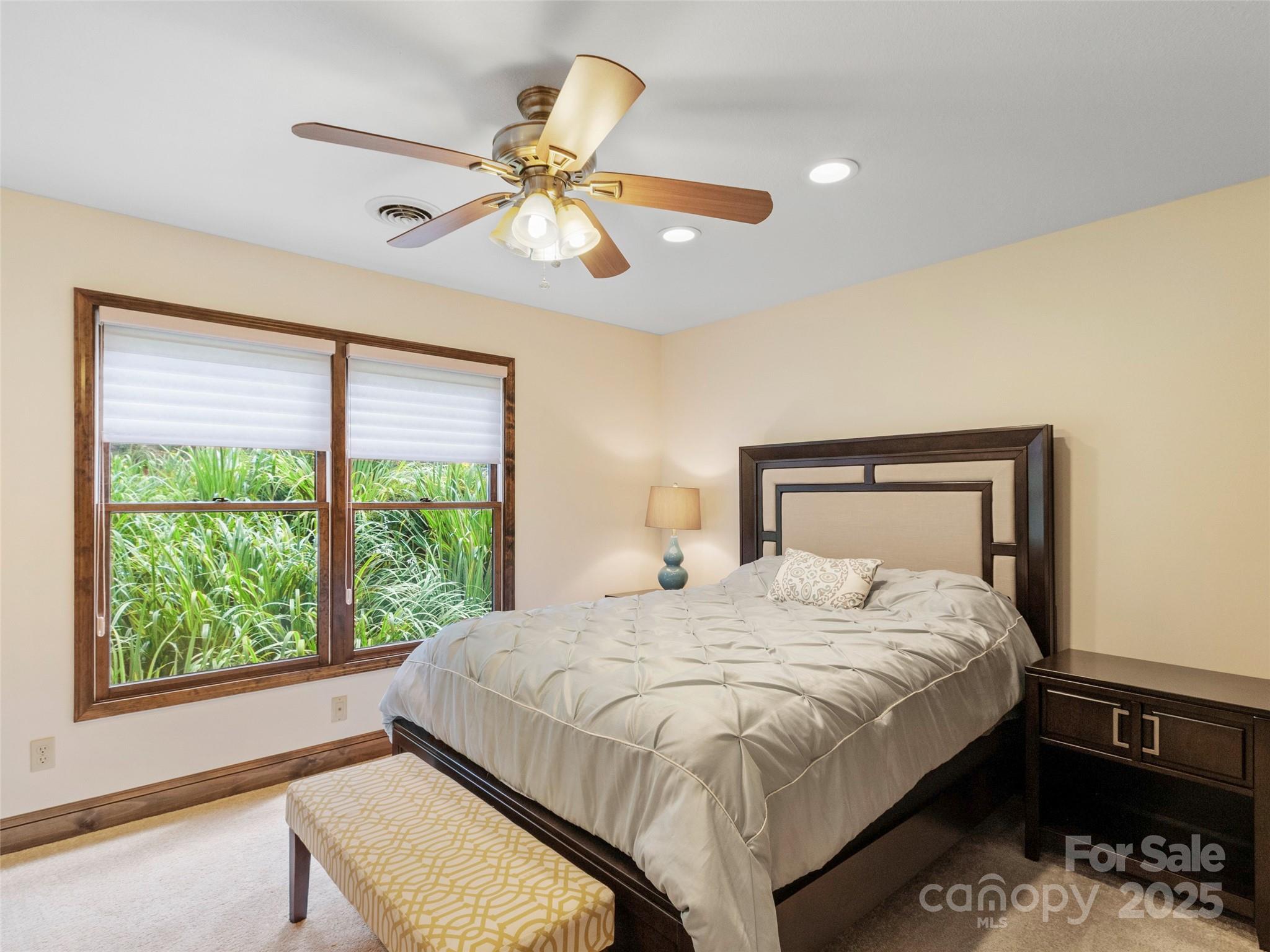 91 Brandy Run Road Burnsville, NC 28714 - Photo 24 of 48 a bedroom with a large bed and a window