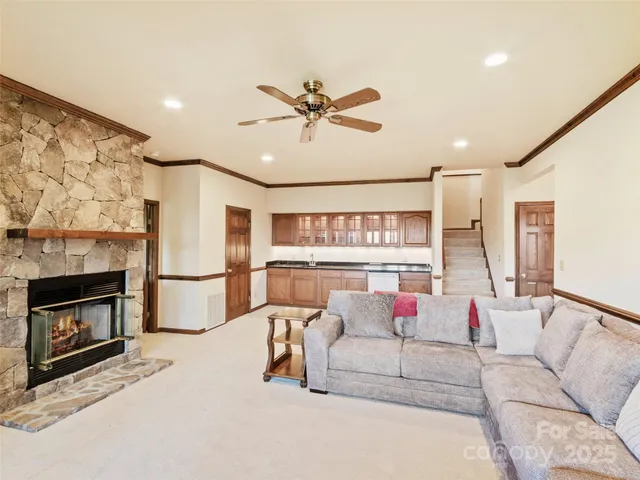 a large white kitchen with granite countertop a sink and a refrigerator