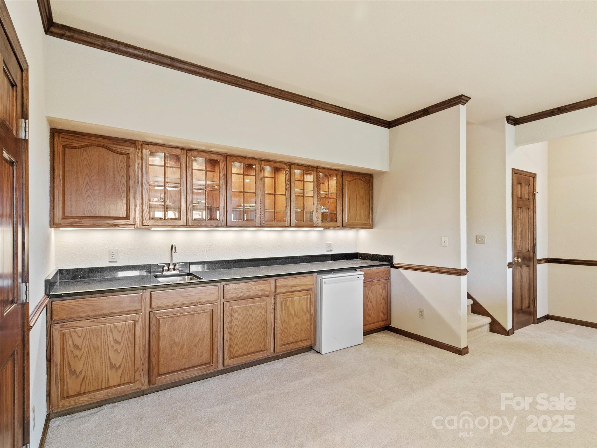 91 Brandy Run Road Burnsville, NC 28714 - Photo 29 of 48 a large white kitchen with granite countertop a sink and a refrigerator