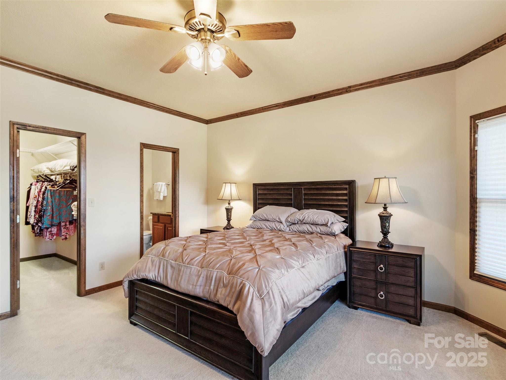 91 Brandy Run Road Burnsville, NC 28714 - Photo 31 of 48 a bedroom with a bed and a chandelier