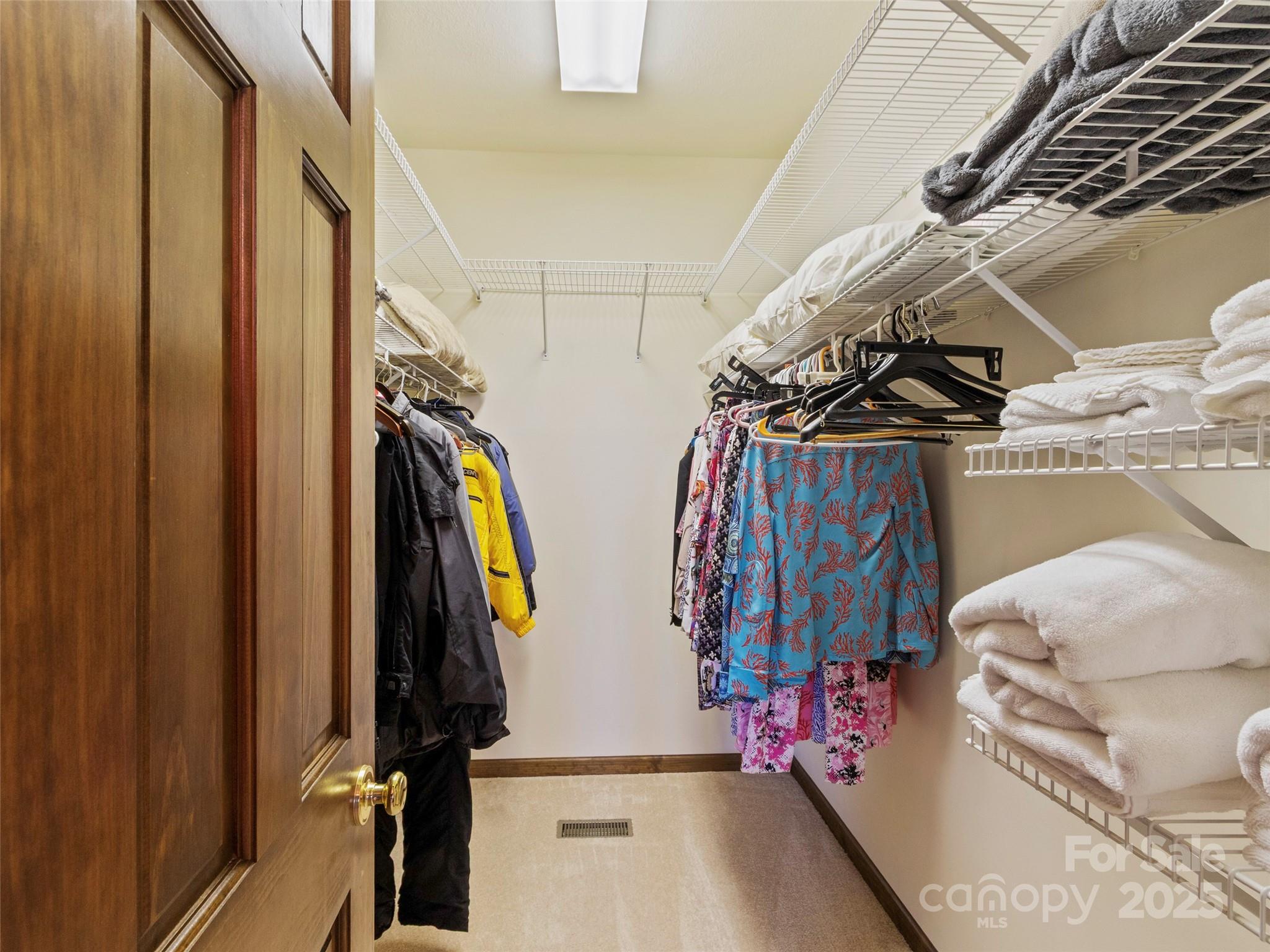 91 Brandy Run Road Burnsville, NC 28714 - Photo 33 of 48 a view of walk in closet with clothes and shoes