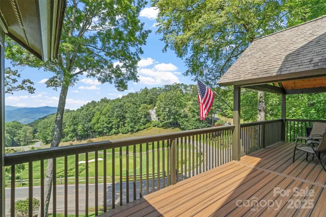 a view of a wooden deck next to a yard