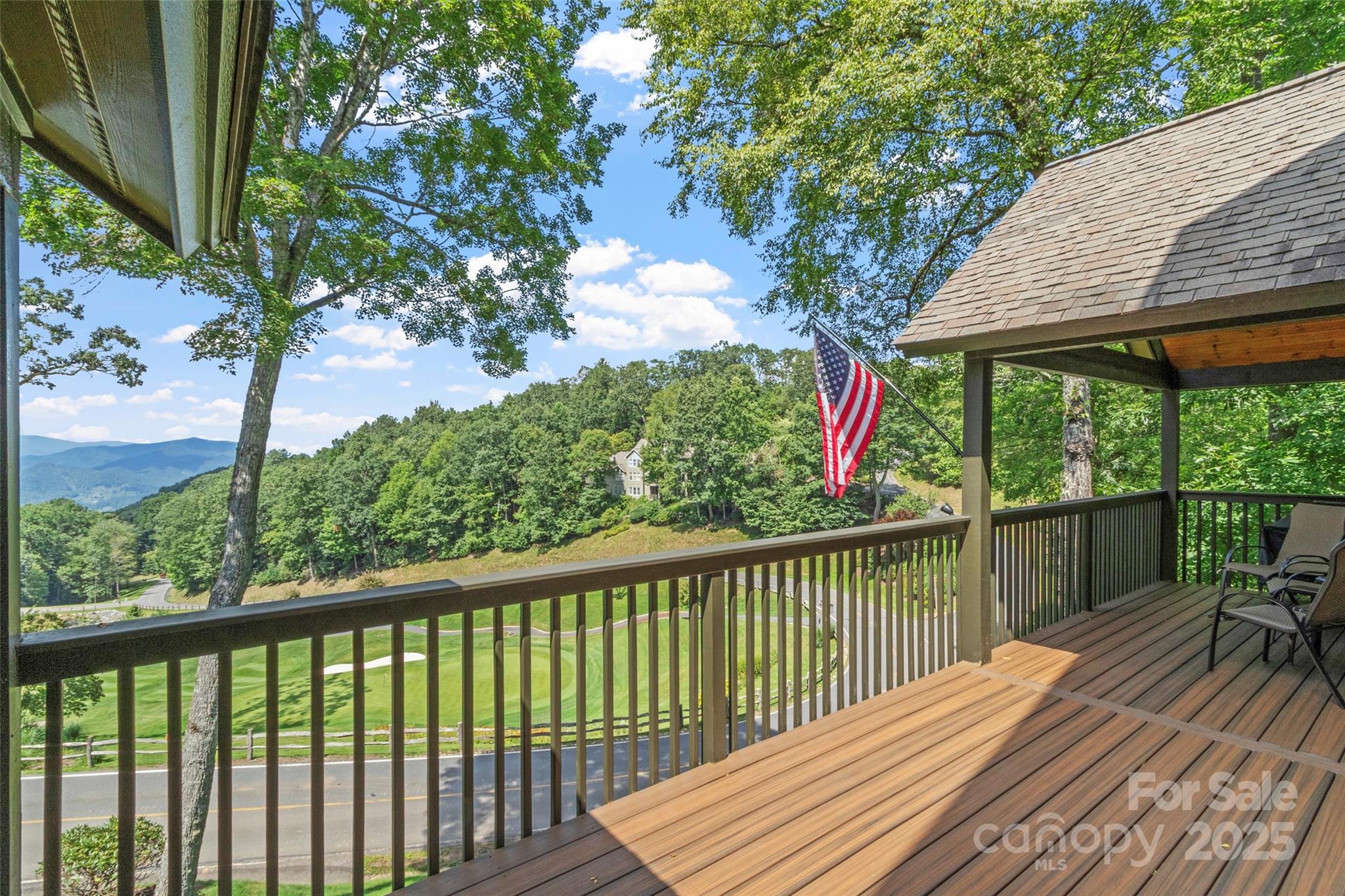 91 Brandy Run Road Burnsville, NC 28714 - Photo 8 of 48 a view of a wooden deck next to a yard