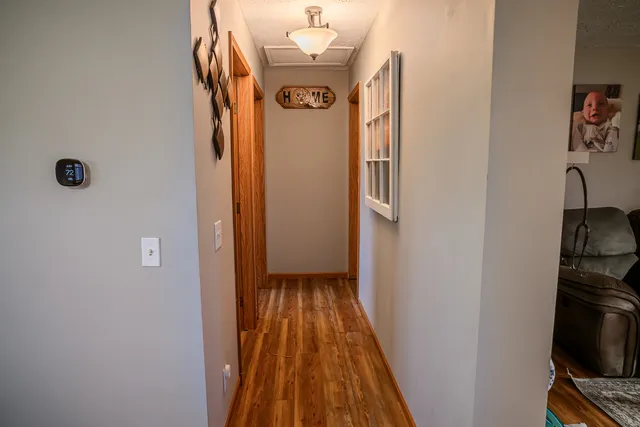 a view of a hallway with wooden floor