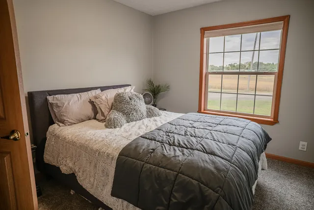 a bed sitting in a bedroom next to a window