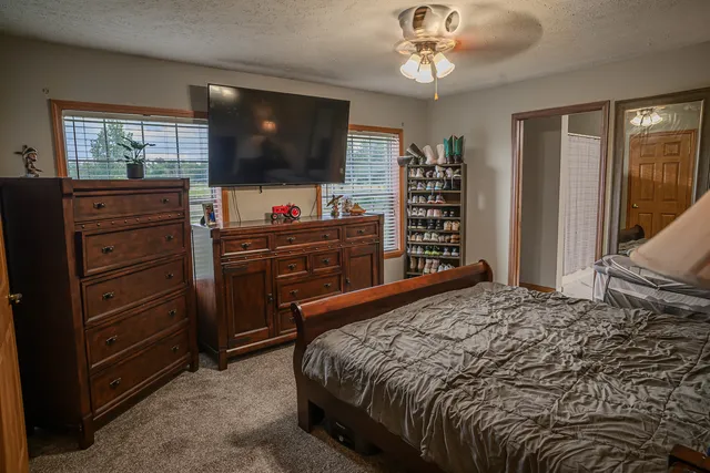 a bedroom with a bed and a flat screen tv