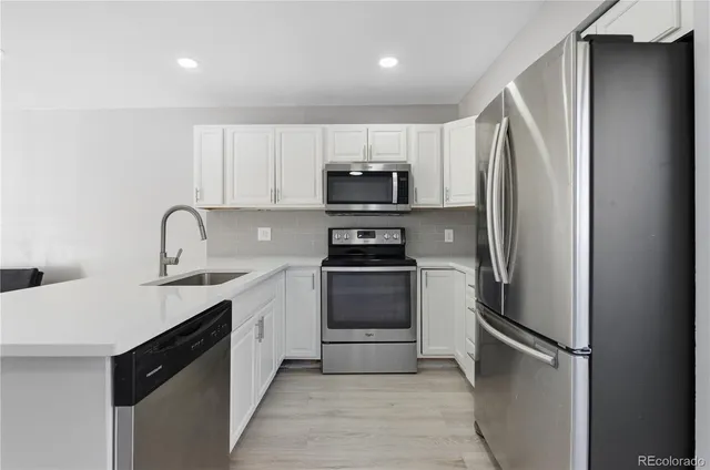 a kitchen with a refrigerator and a sink
