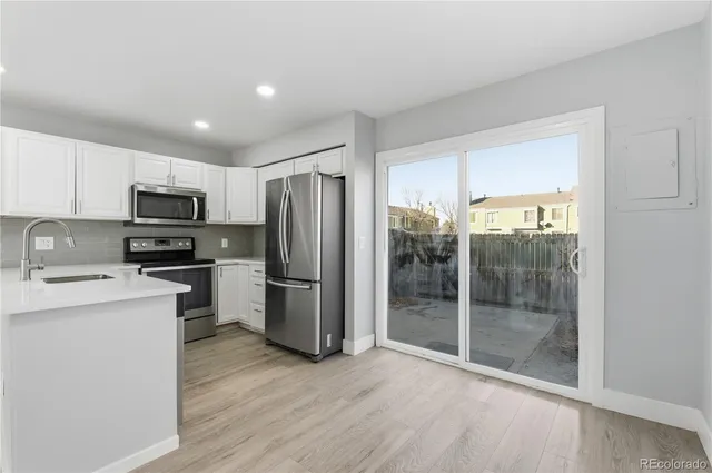 a kitchen with a refrigerator and a sink