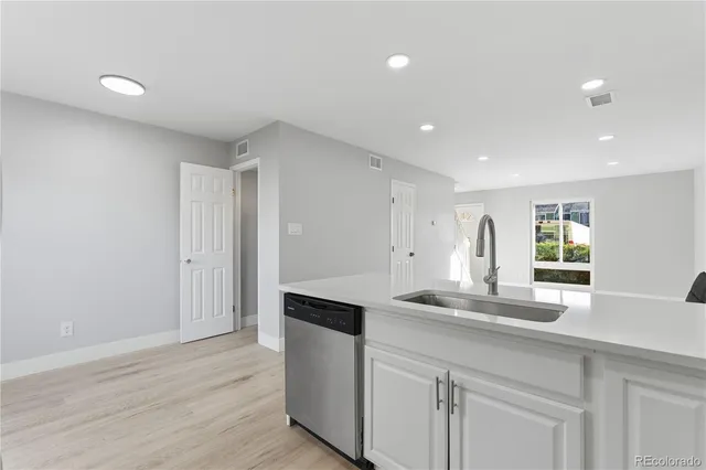 a kitchen with kitchen island a sink appliances and cabinets