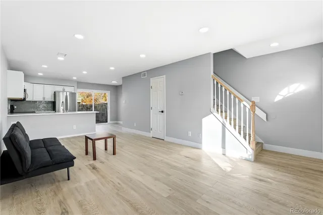a view of kitchen with furniture and wooden floor