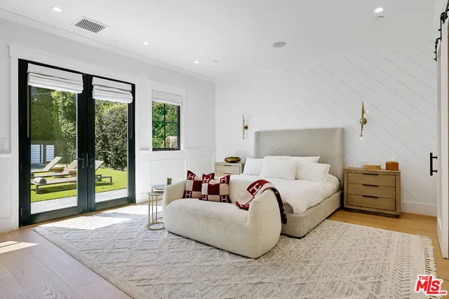 a bedroom with a bed and large window