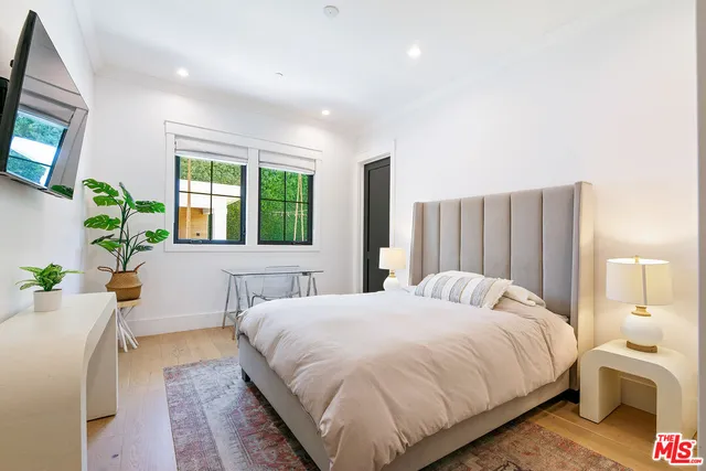 a bedroom with a bed and a couch