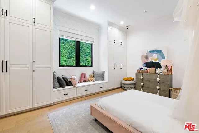 a bed room with a bed and a large window