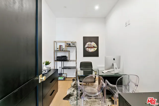 a living room with furniture a rug and a table