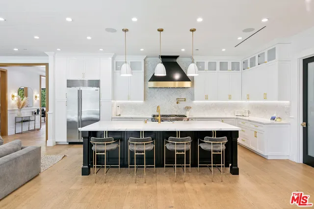 a large kitchen with a table and chairs in it