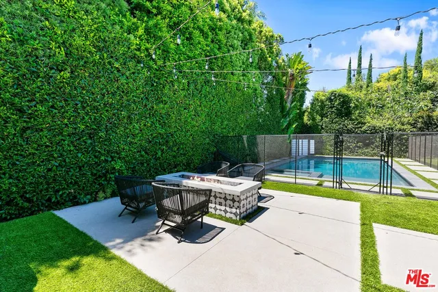 a view of a backyard with swimming pool