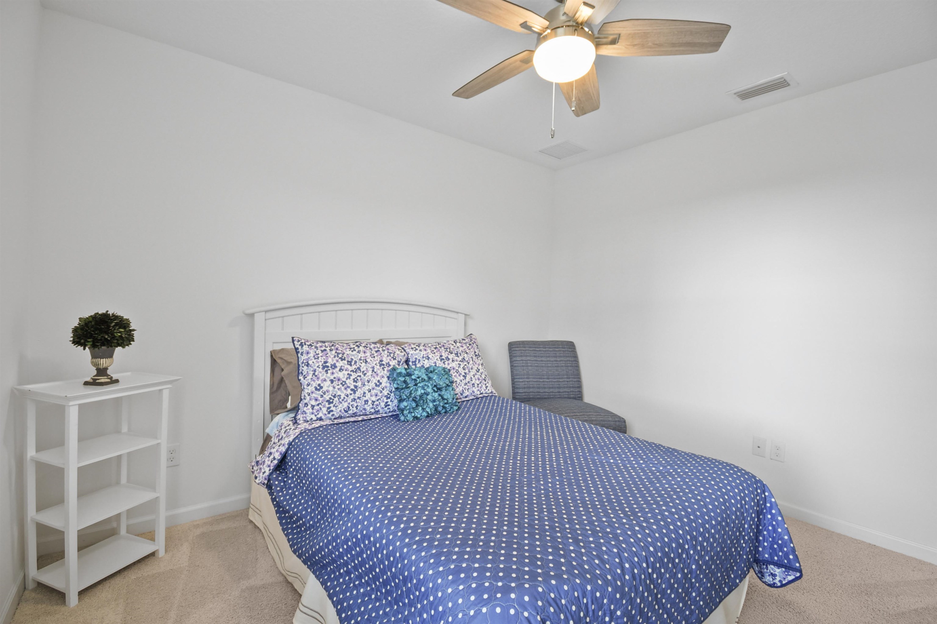 105 Ridge Lake Road St. Augustine, FL 32086 - Photo 26 of 34 a bedroom with a bed and a chandelier