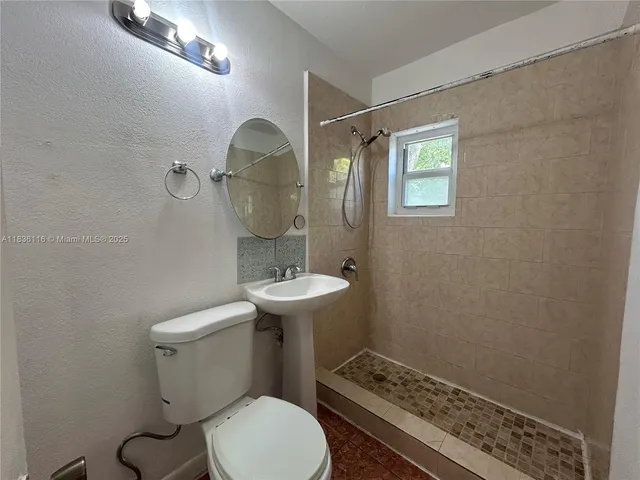 a view of a yard with plants and trees