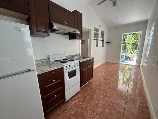 a kitchen with stainless steel appliances granite countertop a stove and a refrigerator