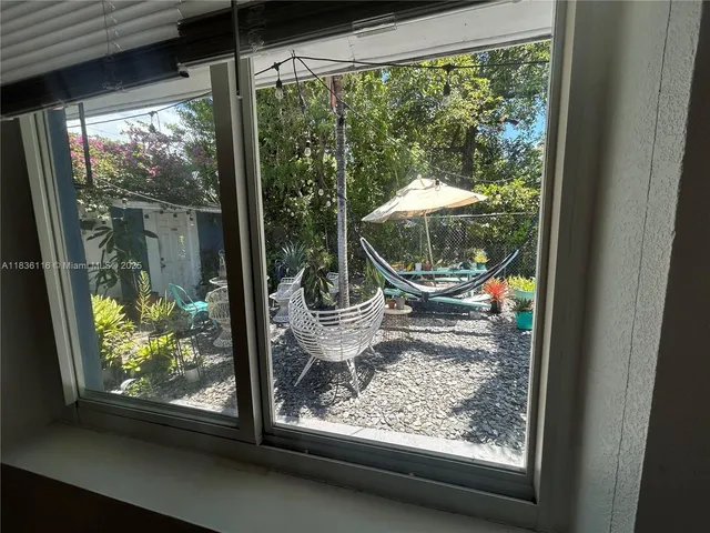 a view of a porch and garden