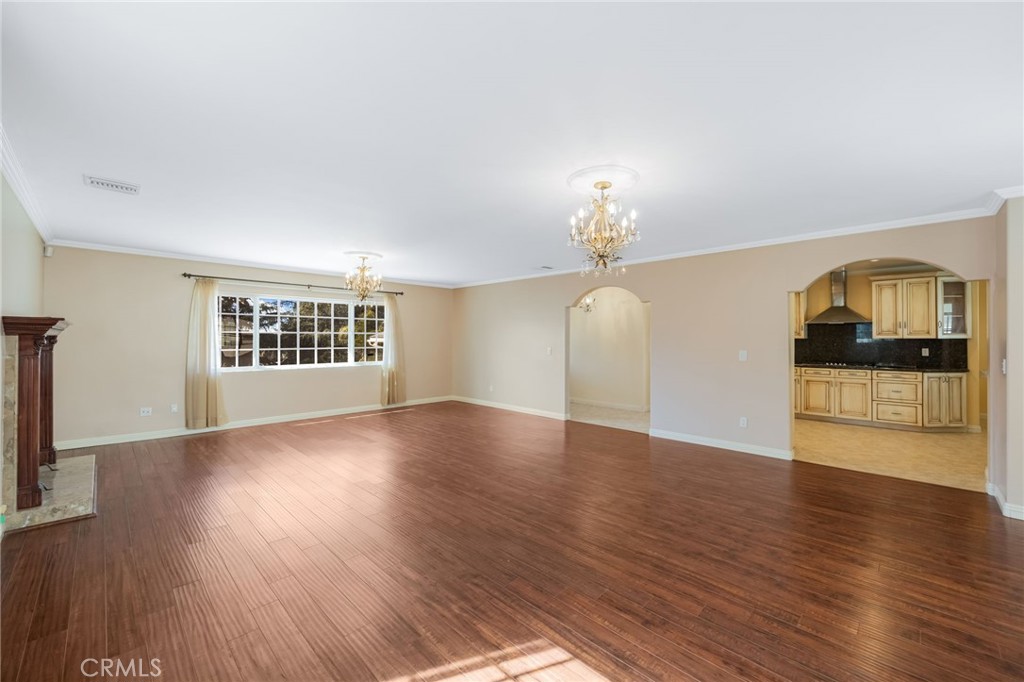 6249 Delfino Street Tujunga, CA 91042 - Photo 13 of 40 wooden floor in an empty room with a window