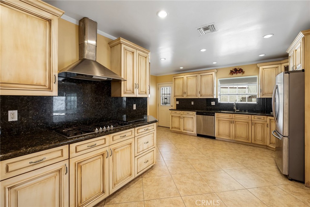 6249 Delfino Street Tujunga, CA 91042 - Photo 17 of 40 a kitchen with stainless steel appliances granite countertop a stove a sink and a granite counter tops