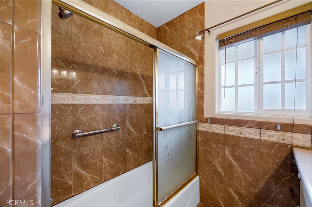 6249 Delfino Street Tujunga, CA 91042 - Photo 33 of 40 a bathroom with a bathtub and shower