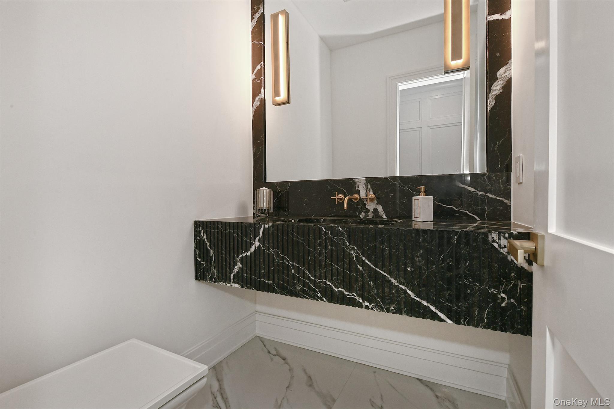 20 Knollwood Road Glen Head, NY 11545 - Photo 25 of 50 a bathroom with a sink and a mirror