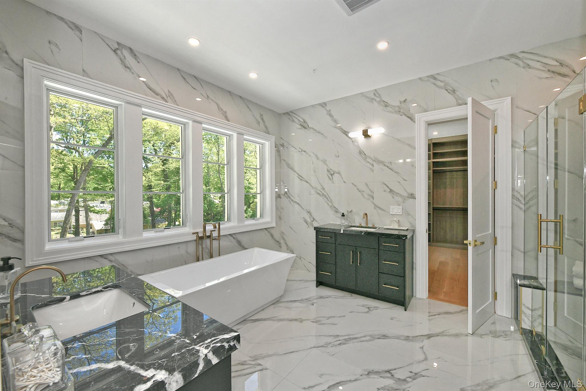 20 Knollwood Road Glen Head, NY 11545 - Photo 30 of 50 a spacious bathroom with a granite countertop tub shower and sink