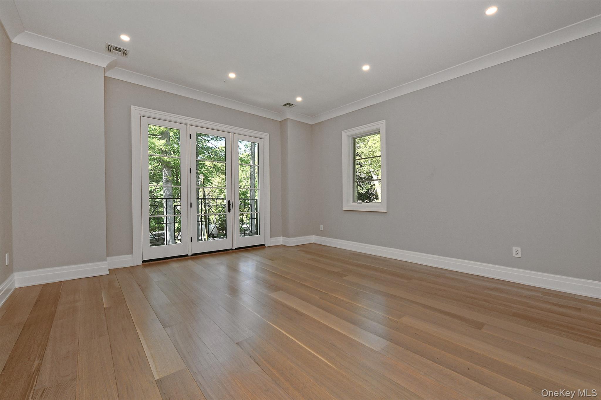 20 Knollwood Road Glen Head, NY 11545 - Photo 32 of 50 a view of an empty room with wooden floor and a window